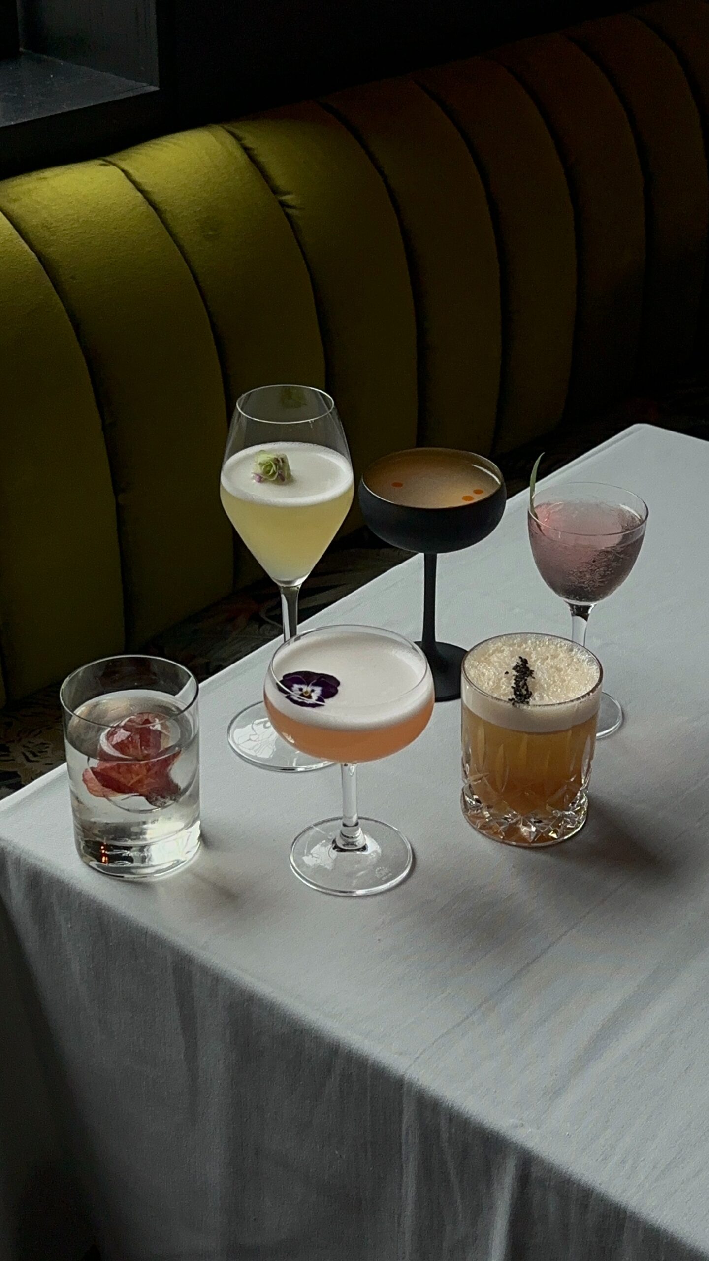 A table of ready to drink cocktails next to a green velvet couch as CPG social media strategist Sarah Price explains whether being meta verified is worth it